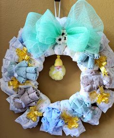 a wreath made out of diapers with a teddy bear on it