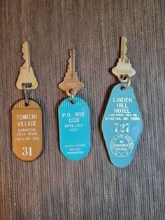 three different types of luggage tags hanging on a carpeted floor with the names of hotels and motels