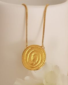 18K gold plated tribal spiral pendant necklaceThis simple design is perfect for every day, layered or worn alone.Lovely as a bridesmaids gift or as wedding jewelry! Each necklace will arrive in a black gift box. Spring clasp closure on 2 mm chainPendant Height: 20 mmPendant Width: 18 mmThe gold plating is a high quality 3 microns 18k gold thickWeight: 5 GramModel is shown with 17-inch chainSelect chain length at checkoutThis Necklace has Matching earrings: https://etsy.me/2V4iYHHSKU TP0147Custom Thick Gold Ring, Wide Wedding Rings, Hammered Pendant, Spiral Pendant, Spiral Necklace, Boho Chic Necklace, Necklaces Women, Black Engagement Ring, Going For Gold