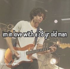 a man playing an electric guitar with the words i'm in love with a 28yr old man