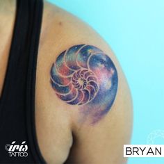 a woman's arm with a tattoo on it that looks like a spiral design