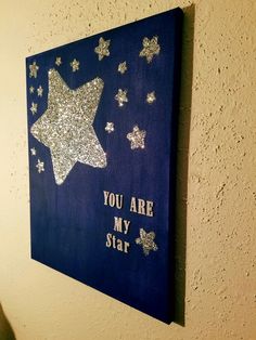 a blue canvas with glitter stars and you are my star written on it