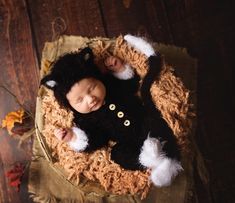 a baby is laying on top of a brown blanket