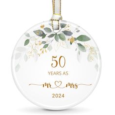 the 50th anniversary ornament for mr and mrs, with gold lettering on it