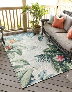 an outdoor area rug with tropical leaves and flowers