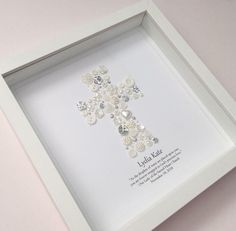 a white frame holding a cross with buttons