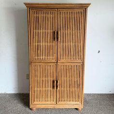 a tall wooden cabinet with two doors