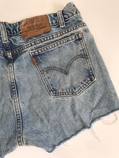 "Waist:32\" Rise:11.5\" Hips:39\" Inseam:2\" These are shown on a size 32\" model and are tagged a 34\" but are true vintage and run small. They're rad 90's 505 cutoffs with the rare orange Levis tab and tons of distress and rips by the raw hem. They're the perfect edgy summer shorts to pair with your Harley crops and band tees. 🍑(15)" Cutoff Jean Shorts With Pockets, Vintage Cutoff Jean Shorts In Medium Wash, Vintage Medium Wash Cutoff Jean Shorts, Vintage Ripped Cutoff Jean Shorts, Vintage Medium Wash Jean Shorts With Frayed Hem, Vintage Cutoff Jean Shorts With Belt Loops, 90s Style Cutoff Jean Shorts In Medium Wash, Vintage Fitted Cutoff Jean Shorts, Fitted Vintage Cutoff Jean Shorts