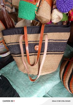 You don't have to be a millionaire to elevate your style and fashion, you need creativity and Arts. We African 1 Stores offers to you the most modern hand made tote bag woven 100% from sisal with Quality leather straps locally tunned from cows.  These beautiful handmade Tote bag originated from craftsmen living in Eastern Community in Kenya, the Akamba. Our Tote bags are woven using colored sisal and leather.The woven bag is made from products which are entirely eco-friendly and sustainable, leather to provide comfort and padding. Leathers are naturally tanned from cows. It has a zipper and an inner lining. This Tote bag is really stylish, functional and eco-friendly for everyday use, summer travels and beyond. From travel to work or a night out, makes it easier to fill your closet with et Black Woven Beach Bag Made Of Natural Fiber, Travel Woven Jute Straw Bag, Woven Jute Straw Bag For Travel, Woven Jute Bucket Bag For Travel, Travel Bucket Bag In Woven Jute, Basket Shoulder Bag In Natural Fiber For Travel, Natural Woven Travel Shoulder Bag, Basket-shaped Natural Fiber Shoulder Bag For Travel, Casual Straw Bags For Market