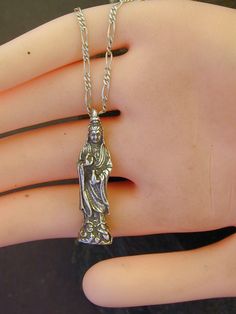 "This solid 3 Dimensional Quan Yin pendant is Sterling Silver. The included chain is a Sterling Silver Figaro 50 chain. You may choose 16, 18 or 20 inch at the same price. Other length available at sightly higher prices. This Quan Yin pendant measures 1 3/8\" tall by 3/8\" across. I hand cast all my pieces using the lost wax casting method. Please ask your needs. You may call me with questions, often I am out so please use my machine. 831-476-3176. Satisfaction Guaranteed! I send items USPS Firs Spiritual Silver Chain Necklace, Hand Cast Pewter Pendant Necklace, Spiritual Silver Square Pendant Jewelry, Antique Sterling Silver Necklace With Lost Wax Casting, Lost Wax Casting Pendant, Quan Yin, Nickel-free Sterling Silver Spiritual Charms, Celtic Heart, Silver Wolf