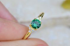 Round Cut Emerald Engagement Ring, 14K Gold Emerald Ring,  Dainty Wedding Emerald Ring, Anniversary Ring, Gift For Her, Mothers Day Gift Item Main Gemstone: AAA Grade Emerald Cubic Zirconia Side Gemstone: AAA Grade White Cubic Zirconia  Size: 4*00 - 1*40 Color: Green Shape: Round Average Quality: AAA+ 🎉All of gold options of the product are produced from solid gold. 🎉While using the product, it's healthier to avoid touching the cream and similar products in terms of cleaning the product. 🎉Items are shown larger in pictures to show details-please note the dimensions. Package 🎀 All of these products are sent carefully packed in elegant jewelry boxes. 🎁 How to order 🤳🏼 🎉First step: Click on the product. 🎉Second Step: Select the material. 🎉Third Step: Select the ring size. Production Emerald Birthstone Ring, Gold Emerald Ring, Smaragd Ring, Dainty Wedding, Emerald Birthstone, Emerald Ring Gold, Emerald Cut Engagement, Emerald Engagement Ring Cut, Wedding Anniversary Rings