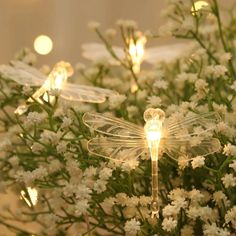 lighted dragon figurines sitting on top of white flowers