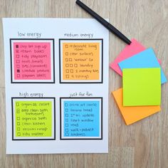 sticky notes and pen on top of a wooden table