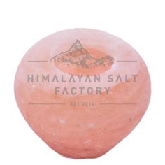 the himalayan salt factory logo is shown on an orange, round soap ball with mountains in the background