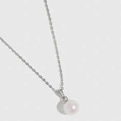 Indulge in elegance with this luminous white freshwater pearl necklace, the perfect match for any occasion. Featuring a timeless gem and a blend of classic and contemporary design, it is thoughtfully curated to highlight your unique style and leave a lasting impression of sophistication. Formal Sterling Silver Necklace With Pearl Pendant, Elegant Sterling Silver Pearl Necklace With Clavicle Chain, Elegant White Necklace With Delicate Chain, Refined White Gold Sterling Silver Necklace, Pearl White Clavicle Chain Necklace, Classic Pearl White Necklace With Clavicle Chain, Pearl White Round Pearl Necklace, Elegant Silver Necklace With Pearl Pendant, Formal Sterling Silver Necklace With Pearl Chain