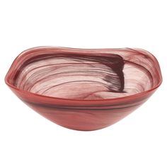 a red bowl sitting on top of a white table