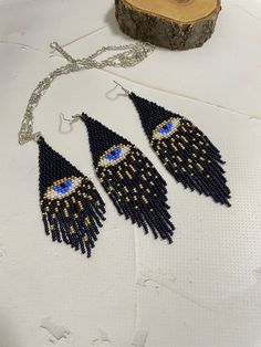 Beaded earrings and pendant from the evil eye. Earrings Made from Czech beads. Length 4.8 inches (12 cm) Width 3.5 cm (width 1.2 inches) Hypoallergenic clasp Pendant Made from Czech beads. Pendant length 3.4 inches (8.5cm). The width of the pendant is 1.4 inches (3.5cm). Chain length 20 inches (50 cm). The length of the chain can be adjusted. The chain is made of stainless steel. If you want these earrings in a different color, write to me and I will be happy to make them for you. Beaded Eye, Evil Eye Blue, The Evil Eye, Beads Pendant, Evil Eyes, Evil Eye Earrings, Cute Box, Earrings Pendant, Blue Evil Eye