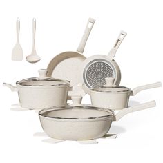 an assortment of white pots and pans on a white surface with utensils