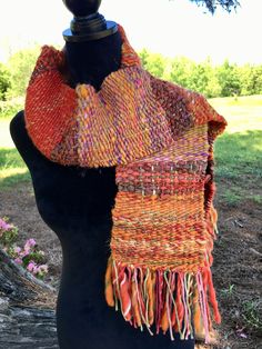 an orange and red scarf is on a mannequin