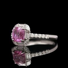 a pink sapphire and diamond ring with white diamonds on the sides, set in 18k white gold