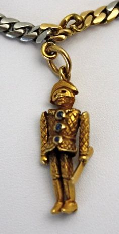 This special charm necklace alternates between links of platinum and links of 18k yellow gold and has an extremely secure lock. Suspended from this unusual chain are five exceptionally unique and very rare enameled charms, all in 18k gold. The detailed clown charm holds a baton and his shirt has three sapphires as buttons. There is also an Uncle Sam charm (enamel could use restoration), a devil with a tail holding a pearl, an American Indian with a tomahawk and feathered headdress, and a lady sw Antique Yellow Gold Enamel Necklace, Antique Enamel Necklace With Hallmark, Antique Enamel Necklace Hallmarked, Antique Enamel Hallmarked Necklaces, Gold Enamel Necklace With Chain, Luxury Charms Necklace, Unique Gold Enamel Jewelry, Luxury Yellow Gold Necklace With Vintage Charm, Antique Enamel Charms Jewelry