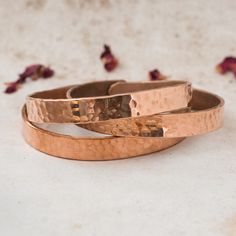 Introducing our Handmade Hammered Copper Bracelets, exquisitely crafted with love in Nepal by skilled artisans who have transformed our vision into a reality. Elevate your style with these timeless accessories that effortlessly blend the essence of hippie and boho aesthetics, meticulously created for the free-spirited souls. PRODUCT DETAILS: - Handcrafted in Nepal - Made from Pure Solid Copper - Unisex design, perfect for all - Free size and Adjustable, ensuring a comfortable fit for everyone ARTHRITIS RELIEF & ONE-OF-A-KIND APPEAL:  Not only do these bracelets add a touch of bohemian charm to your style, but they also offer potential benefits for arthritis pain. Many believe that copper has natural properties that may help alleviate discomfort, making these bracelets as functional as they Nepali Jewelry, Copper Bracelets, Bohemian Bracelets, Minimalist Bracelet, Healing Jewelry, Copper Bracelet, Hammered Copper, Timeless Accessories, Free Spirited