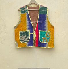 a colorful vest hanging on a wall