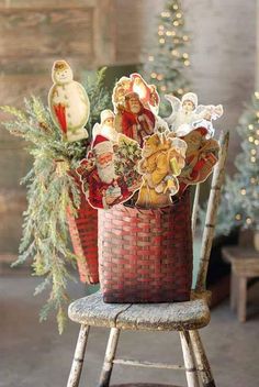 a basket filled with christmas decorations sitting on top of a wooden chair