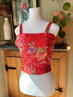 This dazzling Midcentury crop top is vibrantly coloured with a pretty floral pattern. It is covered in iridescent sequins to add sparkle and shine to your outfit while having a tropical feel. The top has spaghetti straps, a fitted waist, and zips up the back with a metal zipper.  Label: Helen H. Halpern Size: none indicated but fits like an extra small (no stretch to fabric except waistband) Measurements (taken flat): Pit to pit - 16.5" Waist - 12" to 13" stretched Shoulder to hem - 17" Pit to h Glamorous Red Sequin Top, Glamorous Summer Festive Crop Top, Vintage Fitted Top For Festival, Fitted Vintage Festival Tops, Fitted Vintage Top For Festival, Red Summer Evening Crop Top, Multicolor Sequined Crop Top, Multicolor Sequin Crop Top, Retro Red Top For Party