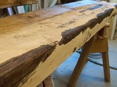 an old wooden bench is being worked on