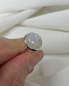 "Fine and Dainty sterling silver ring decorated with a moon stone Material: Silver Stone: MoonStone Available Sizes: J - P All of our jewellery is professionally inspected, All items sold are Genuine Please do not hesitate to contact me if you require any further information or have any problems Any issues I will ensure that they are resolved with 100% customer satisfaction Note: Customized Jewellery is available if you need any jewellery design in any size contacts us right-now to get your desi Sterling Silver Celestial Crystal Ring, Celestial Crystal Ring In Sterling Silver, Silver Celestial Jewelry With Oval Cabochon, Celestial Sterling Silver Crystal Ring, White Sterling Silver Moonstone Ring In Celestial Style, Celestial Moon-shaped Moonstone Ring In Sterling Silver, Silver Moon-shaped Moonstone Ring Gift, Celestial Silver Opal Ring, Sterling Silver Moonstone Ring In Moon Shape