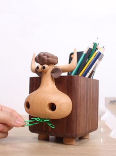 Add a touch of humor to your workspace with our Whimsical Wooden Cow Pen Holder. This quirky pen holder features a playful cow design, perfect for organizing your pens, pencils, and other writing tools. Crafted from high-quality wood, it combines functionality with a fun and lighthearted aesthetic. Ideal for home offices, classrooms, or as a unique gift, this pen holder is sure to bring a smile to your face while keeping your desk tidy and organized. Material:woodenSize:10cm(L)*13cm(W)*15.5cm(H) (1 inch=2.54cm) Wooden Cows Crafts, Office Desk Art, Functional Art Ideas, Wooden Products Ideas, Lighthearted Aesthetic, Wooden Decorative Items, Wooden Home Accessories, Cow Pen, Wood Pencil Holder