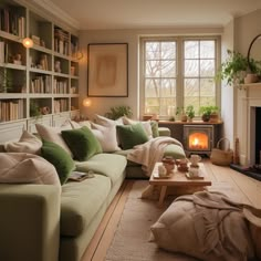 a living room filled with lots of furniture and bookshelves next to a fire place