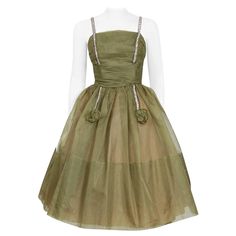 Fashioned from rich olive-green light weight silk-organza, this 1950's creation has everything a woman wants. The boned bodice has a gorgeous pleated texture shelf-bust design. I adore the sparkling rhinestone detail which is so playful and elegant at the same time. The alluring full circle-skirt finishes this beauty off with a perfect New Look silhouette. The perfect Christian Dior vibe! This will be the dress you reach for every time you want to look dynamite. Measurements Bust: 34-35 inches W Aesthetic Evening, Silk Tank Dress, Long Halter Dress, 1950s Outfits, Life Styles, Dresses Aesthetic, Olive Green Dresses, Full Skirt Dress, Brocade Dresses