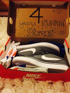 an open shoe box with the number four running strong written on it