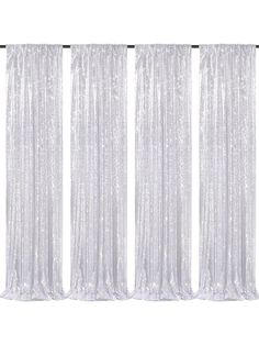 three white curtains with silver sequins on them