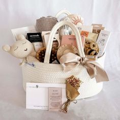 a white basket filled with lots of different types of stuff animals and other things to put in it