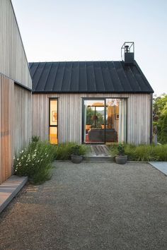 a house that has some plants in front of it