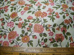 a ruler is next to a flowered fabric