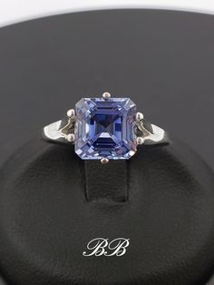 Made to order.  Please allow up to 3 weeks for production of your ring. This listing is for a 925 unplated sterling silver ring with a high quality lab created ceylon blue sapphire gemstone. Gem Type: Lab Created Sapphire Shape: Asscher Cut Size: 8mm Weight: 2.5 carats approximately Quality: AAA Hardness: 9 Mohs Available in the following Metal Options (all are unplated metals) 925 Sterling Silver 10kt White Gold (non-rhodium plated) 10kt Yellow Gold 14kt White Gold (non-rhodium plated) 14kt Yellow Gold 14kt Rose Gold Did you know lab-created sapphires are equivalent to natural sapphires? Lab grown sapphires have the same chemical composition as natural sapphires. They have the same refractive index (sparkle), specific gravity etc. They are made of corundum, the same thing mother nature ma Formal Tanzanite Jewelry With Octagon Shape, Formal Tanzanite Octagon Jewelry, Formal Octagon Tanzanite Jewelry, Luxury Rings With Polished Lab-created Sapphire, Classic Tanzanite Jewelry, Formal Tanzanite Ring With Asscher Cut, Classic Tanzanite Jewelry With Center Stone, Formal Rings With Asscher Cut Lab-created Sapphire, White Gold Tanzanite Rings With Diamond Cut