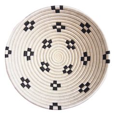 a black and white basket is shown on a white surface with squares in the center