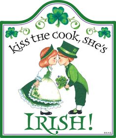 a sign that says kiss the cook, she's irish with two children kissing