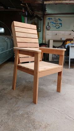 a wooden chair sitting in a garage next to a car