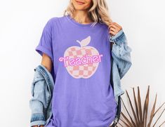 Super cute Barbie back to school teacher t shirt. This comfort colors graphic tee will be a fun way to elevate a cute outfit! You could gift this to someone or grab it for yourself! Sizing: Sizes range from an S-4XL in 6 colors. Shipping: It should take about 2 weeks for your order to arrive at your door. 1-7 business days for processing and 1-10 days for it to be shipped! Returns: I do not accept returns or exchanges so please make sure the size and color is correct before ordering. However, if there is an issue with your order when you receive it, please feel free to reach out to see if we can resolve the problem! Comfort Colors introduces the "Comfort Colors 1717" garment-dyed t-shirt; a fully customizable tee made 100% with ring-spun cotton. The soft-washed, garment-dyed fabric brings Purple Short Sleeve T-shirt For School Spirit, Casual Teacher Appreciation T-shirt For Back To School, Trendy School T-shirt With Crew Neck, Back To School T-shirt With School Spirit Style, Casual Back To School T-shirt With Funny Print, School Spirit T-shirt Relaxed Fit For Back To School, School Spirit T-shirt For Back To School, Casual Back-to-school T-shirt With Funny Print, Casual Funny Print T-shirt For Back To School