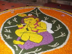 an image of the god ganeshi made out of flowers and petals on display