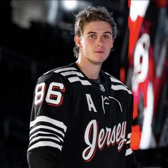 a young man wearing a jersey with the number 86 on it is posing for a photo