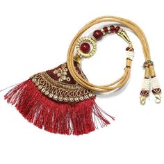 Back Splash - Red Zari Latkan Dori with red beads - Tassel for Necklaces
  Now show off not just your necklace but your back too .. Back Splash 
  Length of the Dori is adjustable upto : 24.00 inches
  This item is NOT made of Gold
  This item does NOT have any Gold in it
  Use this dori - Tassel to attach it to any Necklace
 - 1-DOR163 - in 0.000 Grams for USD $24.99. 
Made in India by Totaram Jewelers Online this product is in Gold - 22 Karat BIS Hallmark 916 KDM Gold  & is an excellent gi