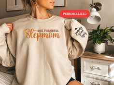 Celebrate the special role of a stepmom this Thanksgiving with the Thanksgiving Custom Stepmom Sweatshirt! This personalized crewneck is a thoughtful gift to show your appreciation and love. Personalized Step Mom Crewneck Gift for Her Make her feel cherished with the Personalized Step Mom Crewneck Gift for Her. This custom sweatshirt is designed to honor her unique place in your life and make her Thanksgiving extra special. Long Sleeve Shirt for Stepmom Turkey Day Ensure she's cozy and stylish w Mom Crewneck, Step Mom, Unique Place, Turkey Day, Custom Sweatshirts, Step Moms, Holiday Festival, Snug Fit, Long Sleeve Shirt