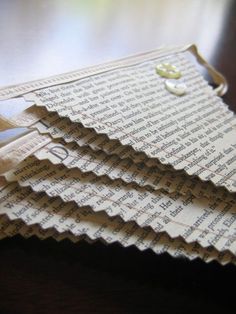 three pieces of folded paper sitting on top of a wooden table