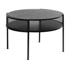 a round table with black metal mesh around it